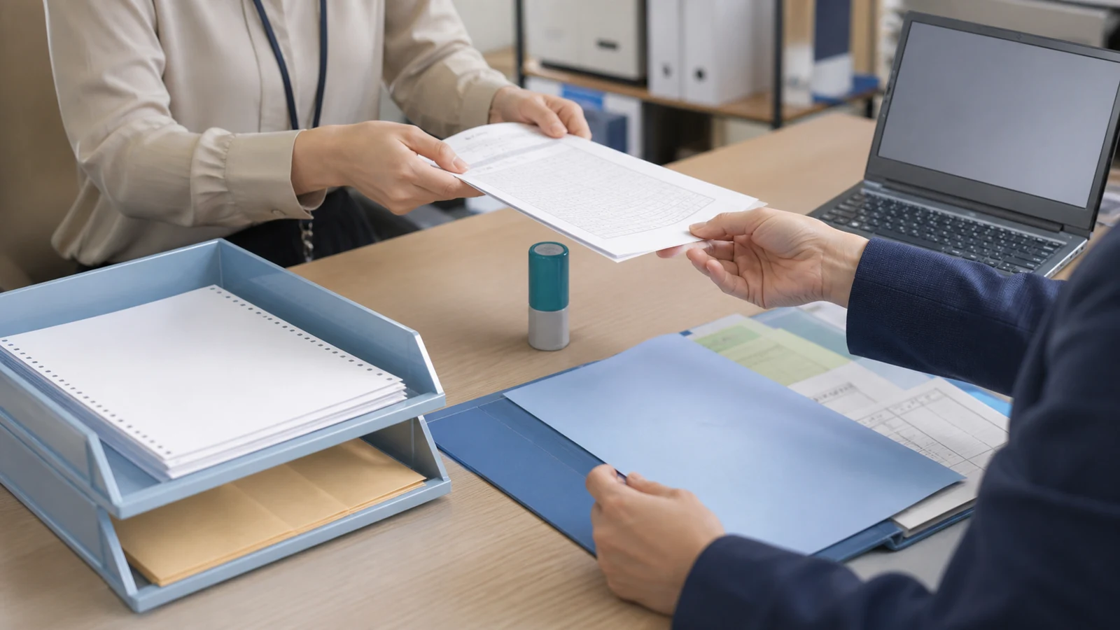 社内事務員が請求と勤怠の資料を整理し経理代行担当者と受渡し表を確認する場面